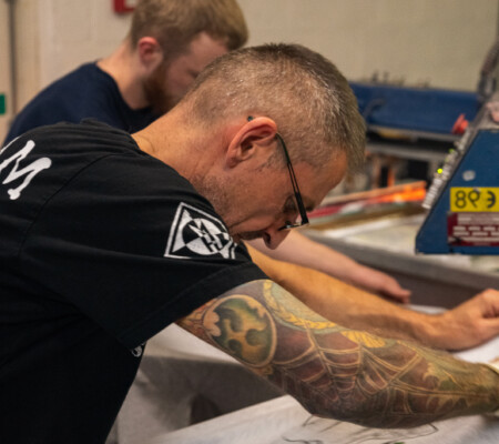 a man operation a screen printing machine