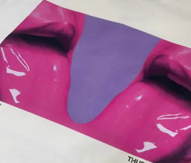 a vibrant pink and purple direct to garment print on a white t-shirt.