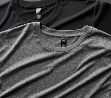 blank garments layered over each other, one grey and one black t-shirt.