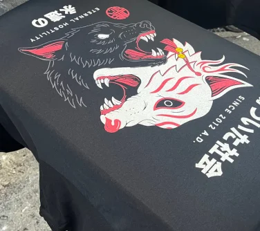 a screen printing design of wolves on a black t-shirt.